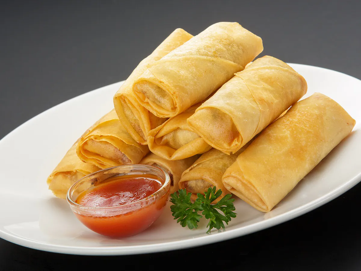 Crispy fried spring rolls served with sweet chili dipping sauce at Lee's Garden, a Chinese Restaurant in Rosenberg